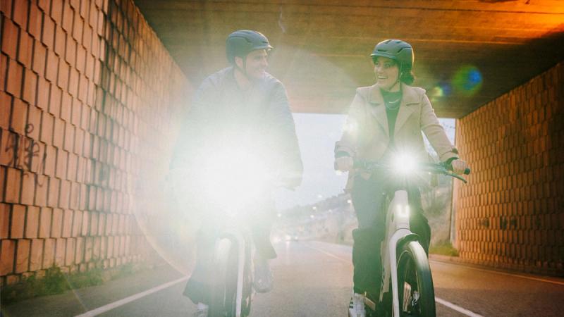 a man and a woman are riding bicycles in a tunnel .