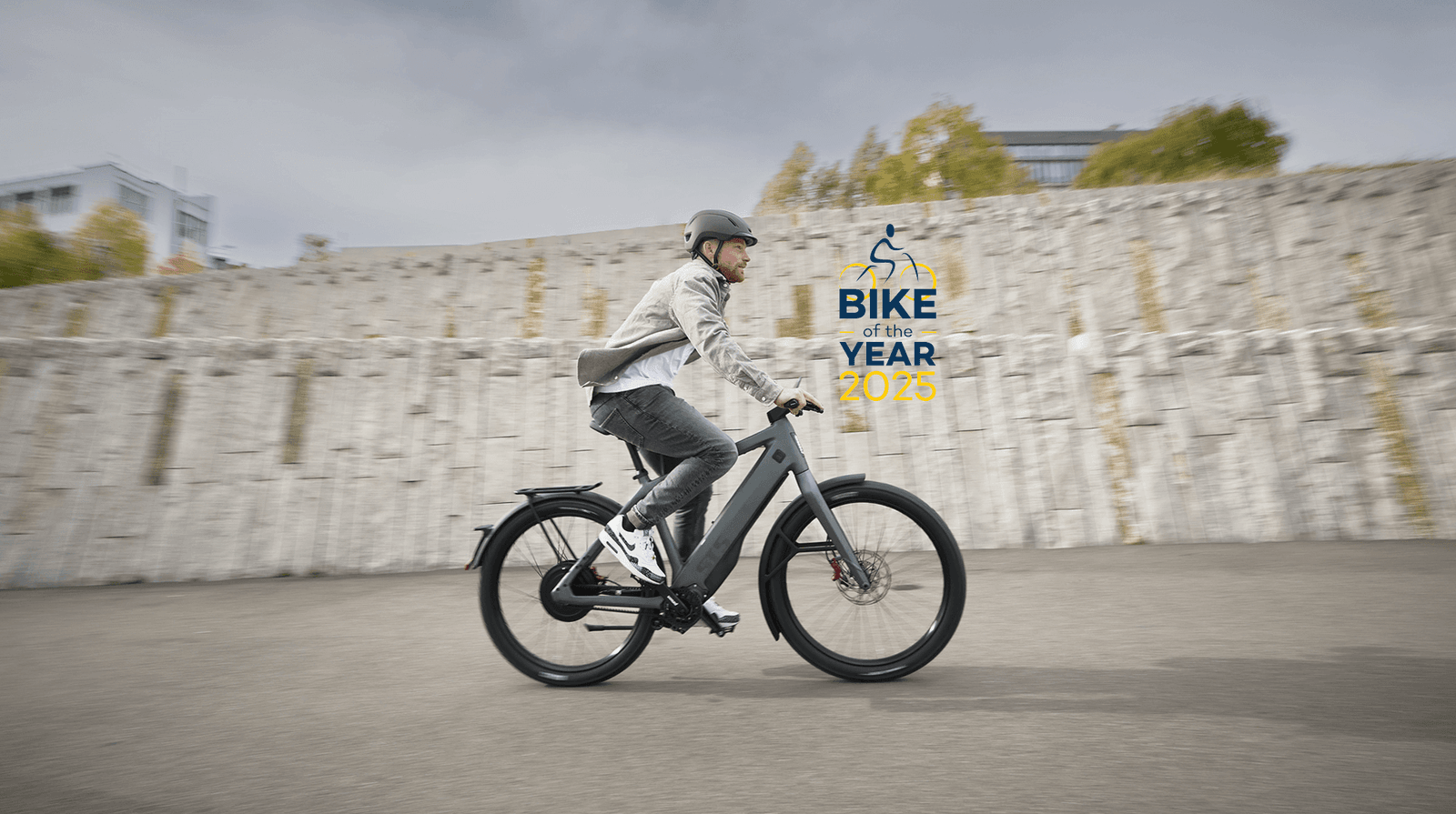 a man is riding a bike in front of a sign that says bike of the year 2075