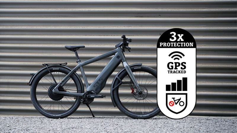 Grey e-bike with a prominent graphic advertising "3x PROTECTION, GPS TRACKED."